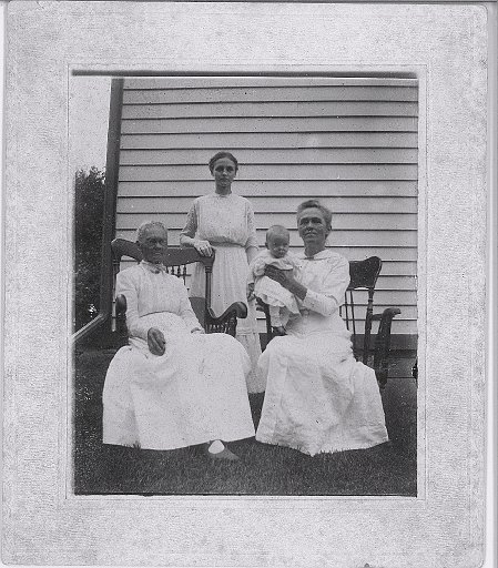 Photo labeled as Aunt Bertha Bray standing.  Baby is her dau